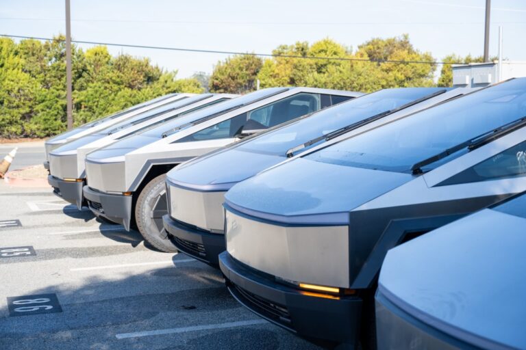 Dozens of unsold tesla cybertrucks are stacked in detroit car